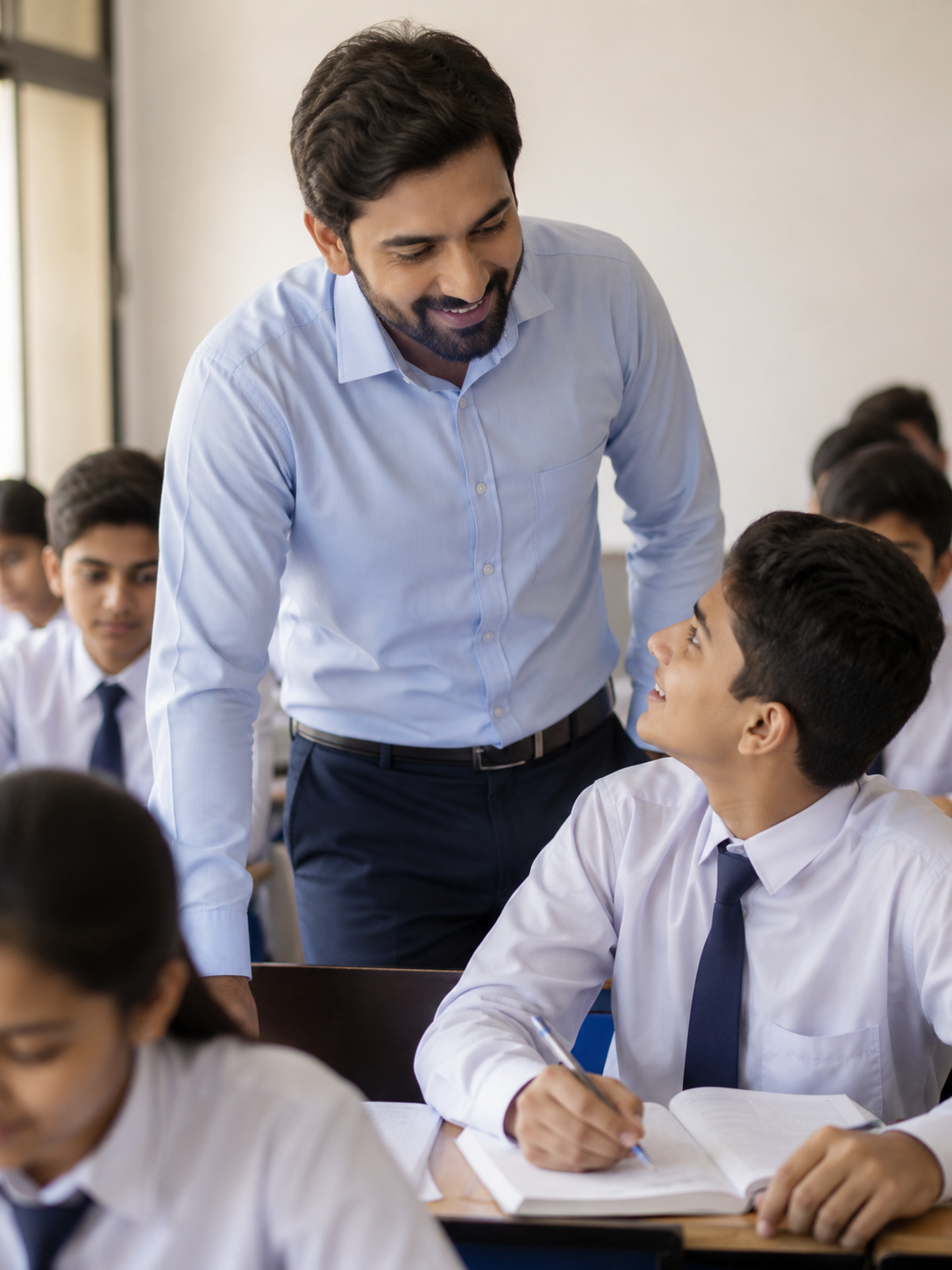 Male teacher with students in classroom